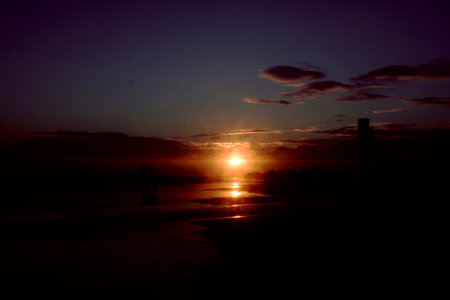 Sunset on the beach with a view of the sea and the bridgeのeditorial素材