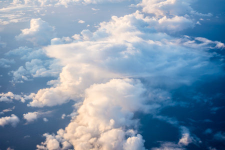 Clouds and sky as seen through window of an aircraft during flight