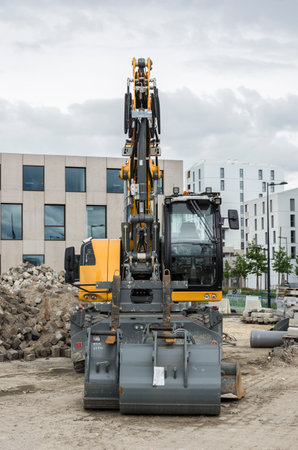 excavator at a construction site on the background of the building