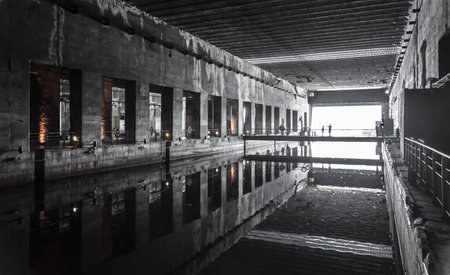 Abandoned factory building with reflection in water. Black and white