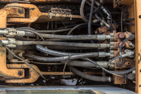Detail of an old excavator with pipes and cables. Selective focus.のeditorial素材