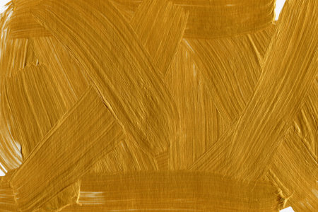 Gold oil paint brush strokes on white background. Abstract art texture.のeditorial素材