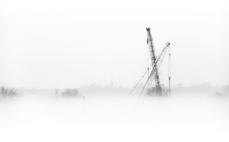 Industrial landscape with cranes on foggy foggy morning.のeditorial素材
