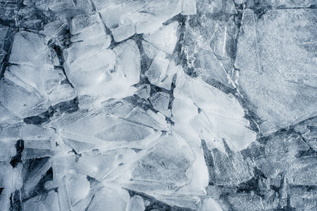 Pieces of ice on the frozen lake in winter. Toned.