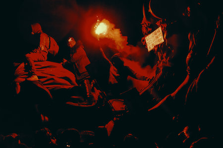 Rock band performing live on stage in a dark room with lights and smoke