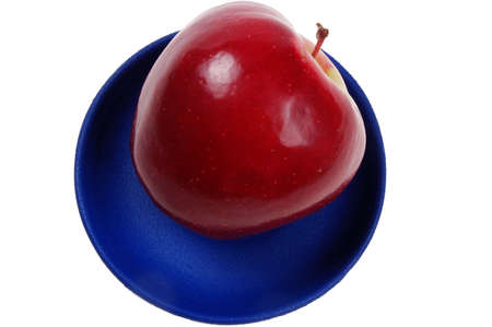 juicy apple on a blue dishの写真素材