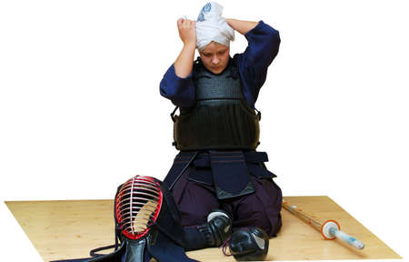 woman puts on kendo uniform. isolated on white