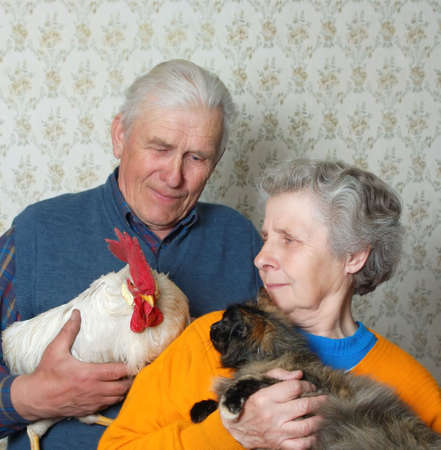 grandfather with rooster and grandmother with pussy-catの写真素材