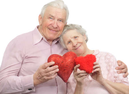happy old couple with red hearts on white backgroundの写真素材
