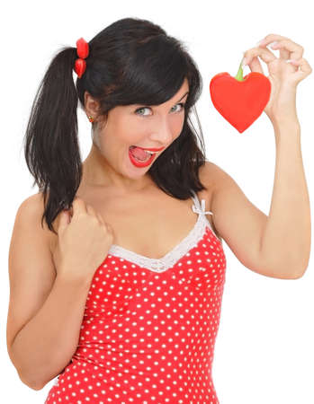 beauty girl with red heart-shaped pepper on white backgroundの写真素材