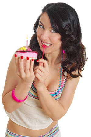 happy young woman and tasty cake with candle. isolated on whiteの写真素材