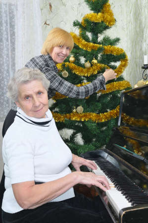granny and daughter prepare to Christmas at homeの写真素材