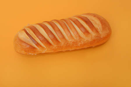 photo of handmade white bread on orange backgroundの写真素材