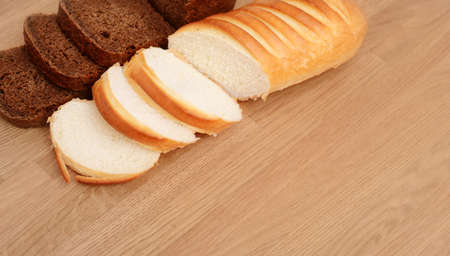 Slice of fresh rye bread isolated on wooden backgroundの写真素材