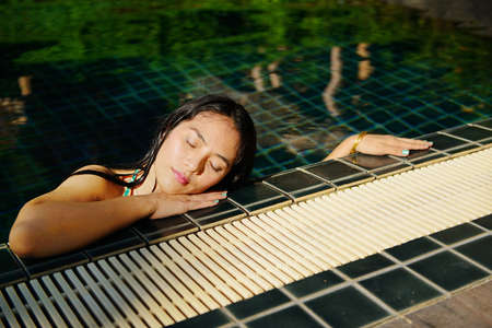 Woman enjoy relaxing in the poolの写真素材