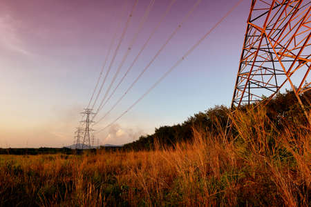 High voltage post or High voltage tower at sunsetの写真素材