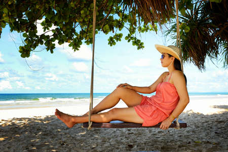Woman enjoy relaxing on the beachの写真素材