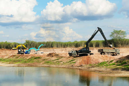 Construction site with many tractors and dump truckの写真素材