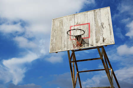 Basketball hoop and wood backboard with blue skyの写真素材