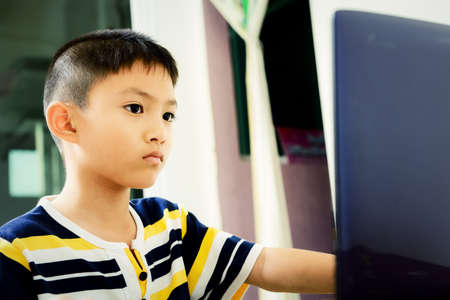 Asian little boy using laptop for knowledge