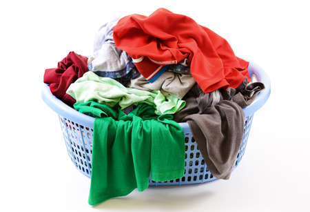Clothes in a laundry basket isolated on white backgroundの写真素材