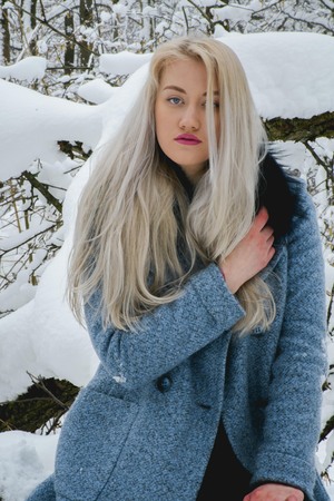 Blonde in the winter forestの写真素材