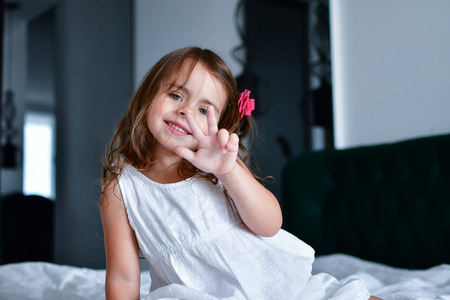 the little smiles girl with a flower in her hair