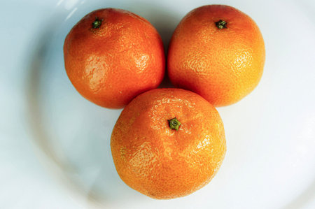 tangerines. tangerines close up on white background. citrus. tropical fruits. three sweet fragrant delicious tangerinesの写真素材