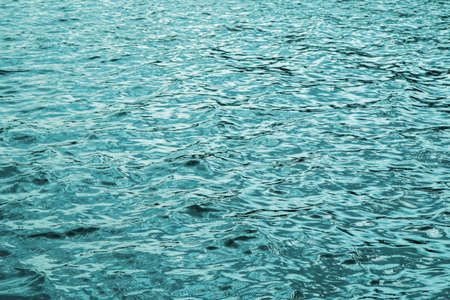 Surface of sea wave close up, low angle view as abstract backgroundの写真素材