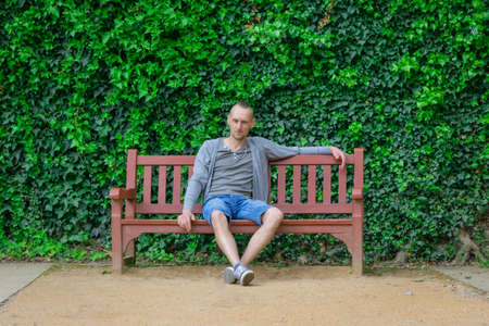 Lonely man sitting on bench. Loneliness conceptの写真素材