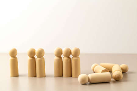 Wooden human figures one by one and in groups, last figures lying down. Advice to distancing. Keep...