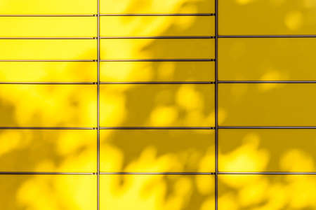 Yellow automated post terminal machine. Leaves shadows on automated self-service post terminal...