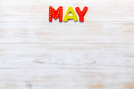 Wooden letters written May month on vintage background. Inscription May with copy space. Top view. Mockup for calendar events. One of 12-month seriesの写真素材
