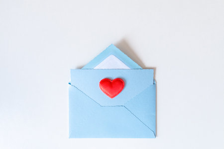 Red heart on a blue envelope for Valentine's Mother, Women's day. Love letter. Gratitude to doctors...