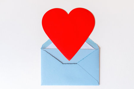 Open blue envelope with big red heart on white background. Love letter with heart. Gratitude to...