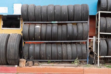 car tires of different sizes stand on the streetの写真素材