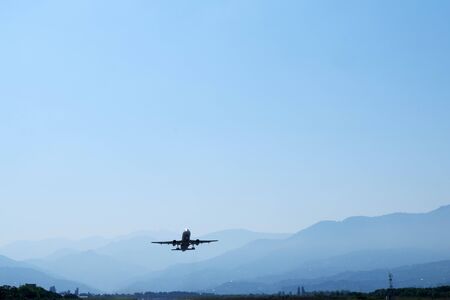 Airplane take off at airport. Passenger plane fly up over take-off runway from airport.の写真素材