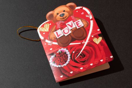 Greeting card with the inscription love and a teddy bear. Valentine's Dayの写真素材