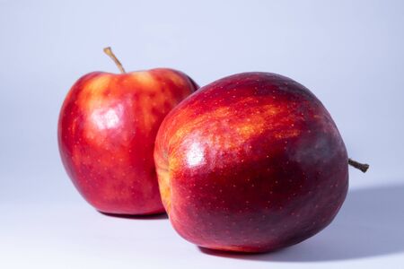Fresh and delicious apple, red ripe apples. Isolated on color backgroundの写真素材
