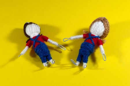 Handmade crochet doll toys on yellow background. Amigurumi dollの写真素材