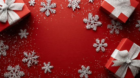 Snowflake-themed Christmas top-view with matte red tones and elegant gift packaging.の写真素材