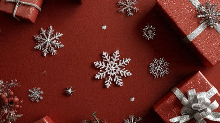 Classic golden star arrangement surrounding red baubles and traditional Christmas gift boxes.