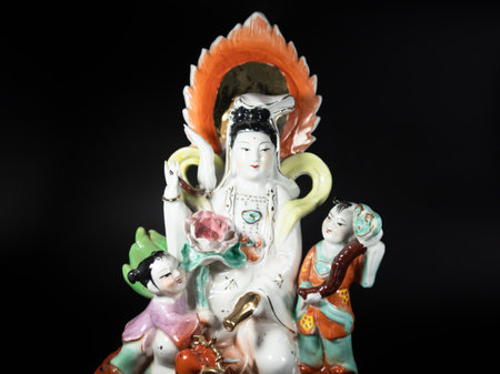 Goddess of mercy, Guanyin the deity figure shoot on black background, focus on the figure.の写真素材