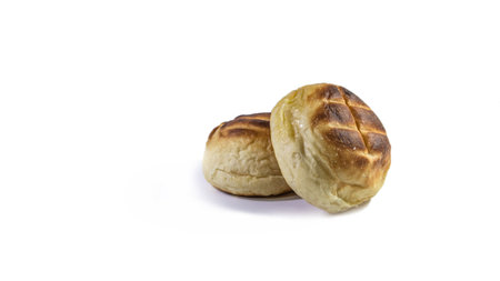 Round bun charcoal grilled serve with crispy bread skin, isolated on the white background.