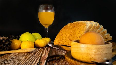 Set of breakfast of the morning, orange juice, whole wheat bread & egg on the wooden dish, side view.の写真素材
