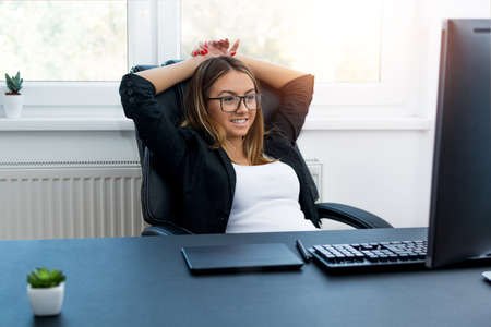 Pretty girl smiling and relaxing in the offcie.の写真素材