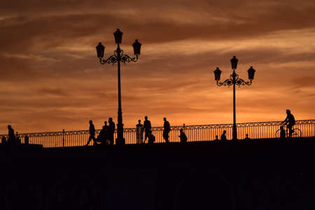 A sunset surrounding a beautiful bridge in Seville a late and warm summer evening.の写真素材