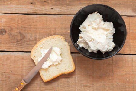 Bowl of cream cheese and fresh breadの写真素材