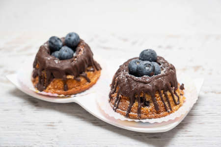 Freshly baked blueberry muffins with chocolate toppingの写真素材