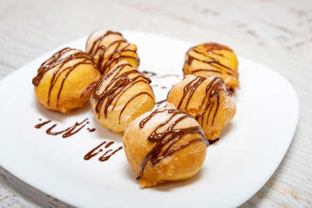 Small dessert donuts with chocolate frosting の写真素材
